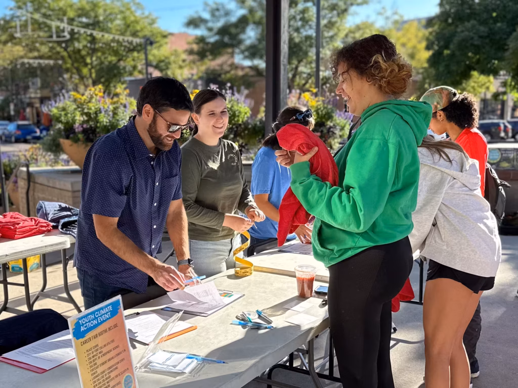 A volunteer checking in a youth at the Youth Climate Action event.