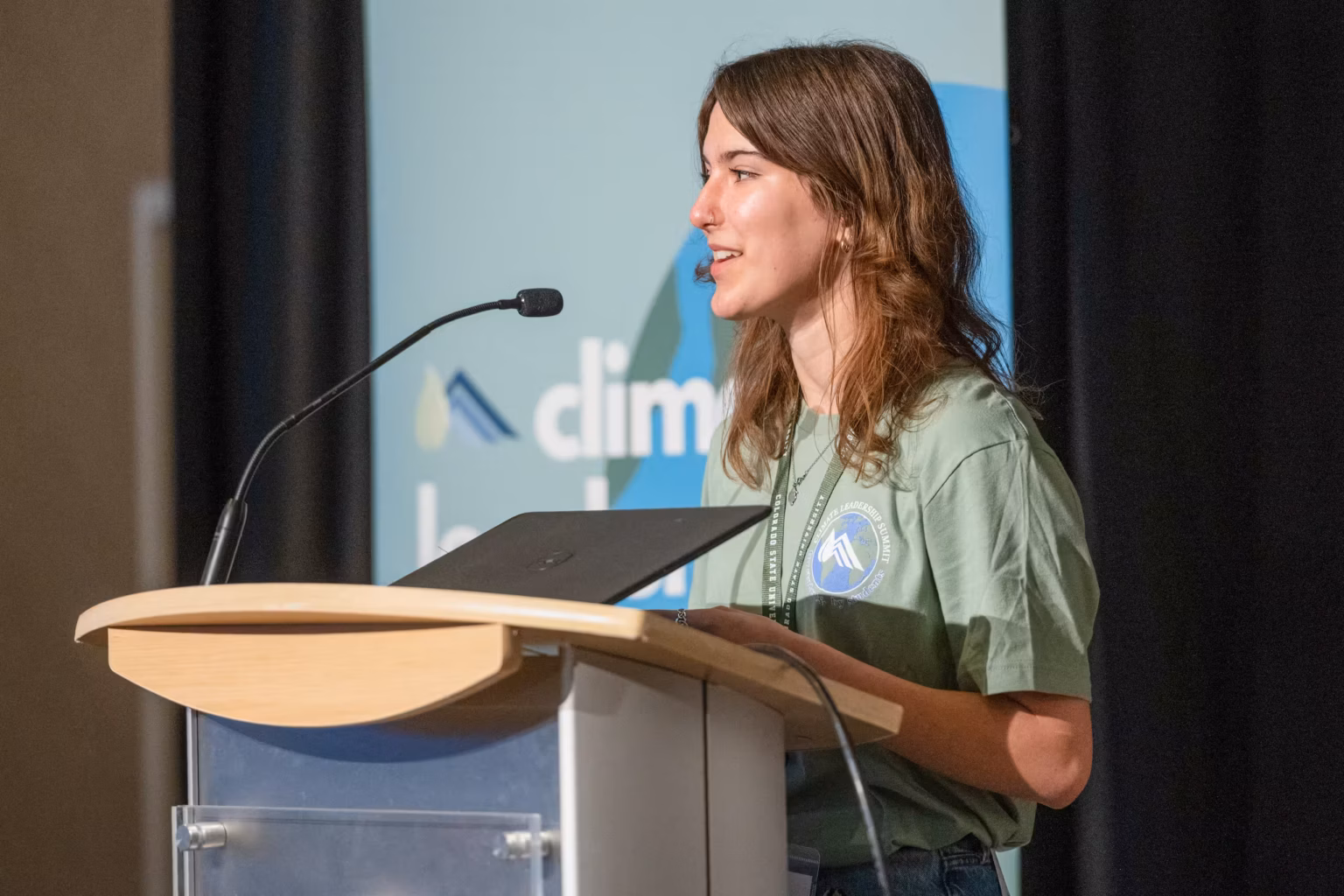 A female high schooler speaking at the Youth Climate Leadership Summit