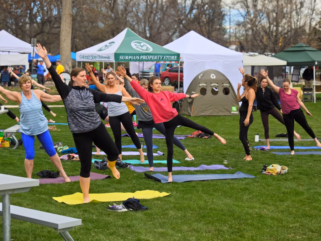 Ladies doing yoga on the lawn at Earth Day Fort Collins